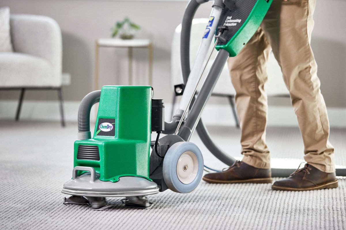 Chem-Dry technician using carpet cleaning equipment